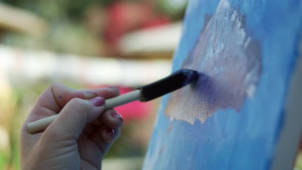 SLOW MOTION video of female artist painting with sponge brush