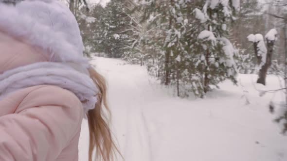 Girl Hand Leading Forward Through Snowy Woods