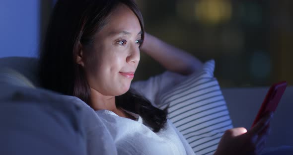 Woman use of smart phone at night