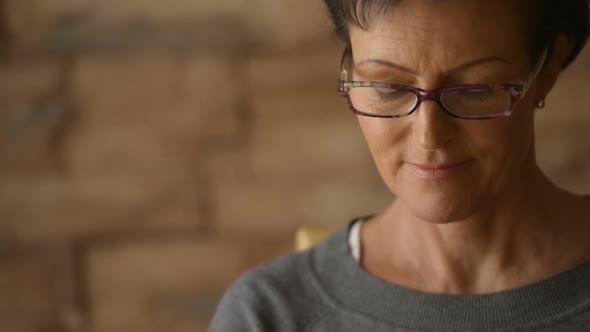 Face of Happy Mature Beautiful Woman Using Laptop with Eyeglasses