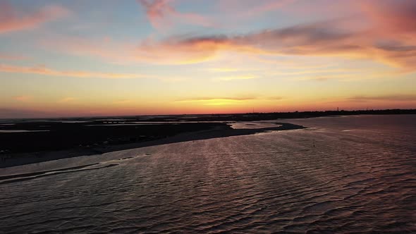 Beautiful Seashore, Colorful Sky and Kitesurfers Gliding in the Sea