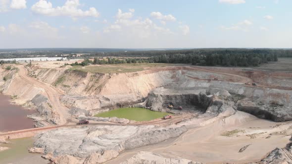 Excavators, bulldozers and heavy machinery working at clay iron ore quarry