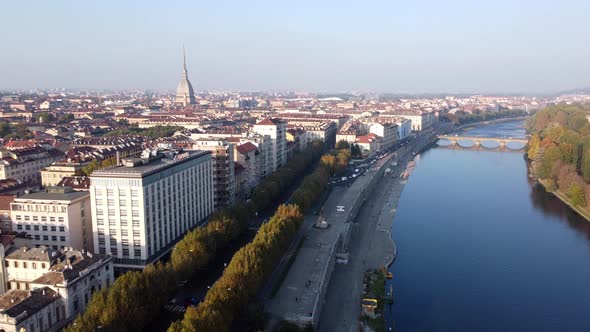 Aerial Reveal Turin City and Mole Antonelliana next to River Po, Fall.