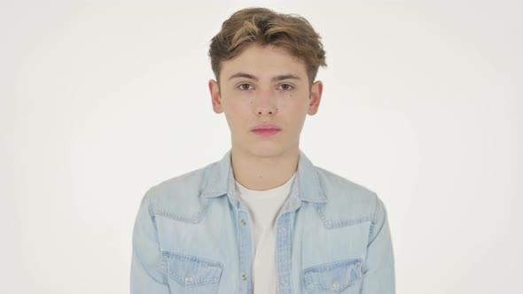 Serious Young Man Looking at the Camera on White Background