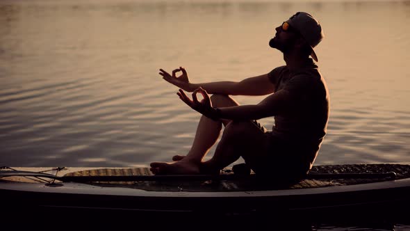 Tourist Meditation Pose Sup Board On Vacation. Standup Paddle Board.Cross-Legged No Stress.