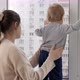 Baby boy with mother looking out of the window - VideoHive Item for Sale