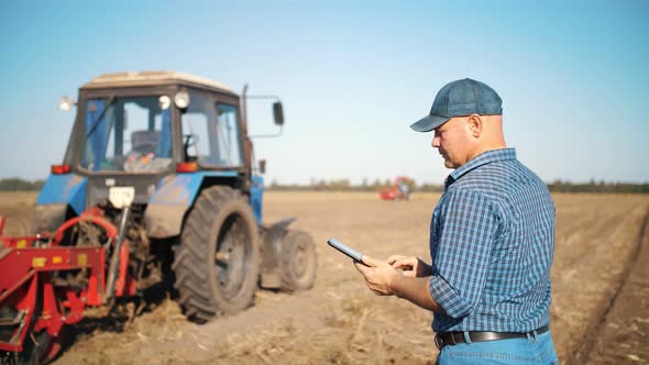 Farmer is Using Digital Tablet