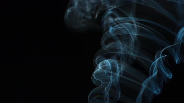 Abstract Smoke Rises Up in Beautiful Swirls on a Black Background