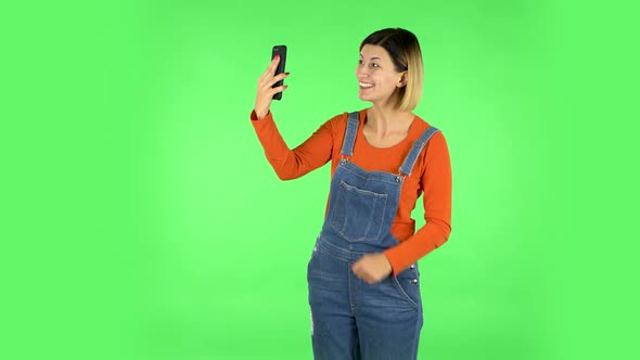 Smiling Girl Talking for Video Chat Using Mobile Phone. Green Screen