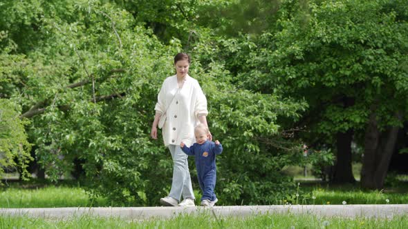 Mother and Child Walking in the Park in Summer Happy 1