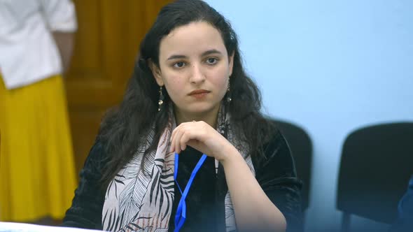 Front View of Young American Girl is Attending Education at Table on Academic Campus Irrl