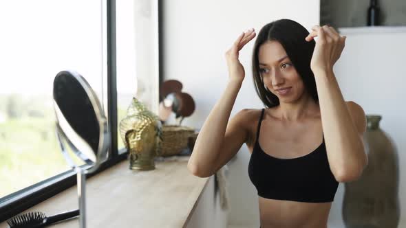 Woman at the Room in Front of a Mirror