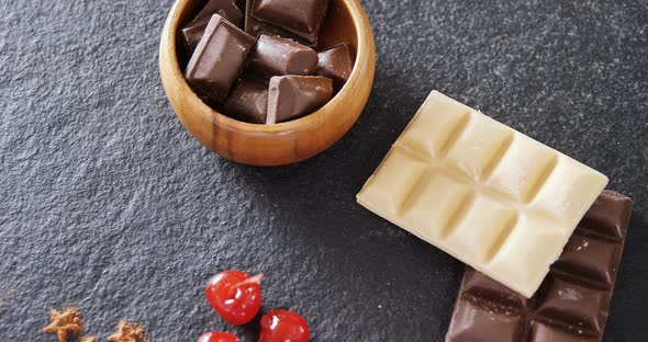 Chocolates and fruit on concrete background 4k