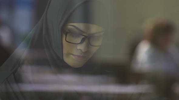 Smart Muslim Woman in Eyeglasses Reading Book, Preparing for Entrance Exams