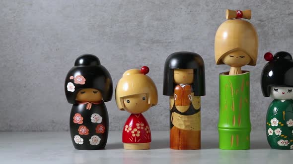 Row of traditional Japanese wooden kokeshi dolls close up