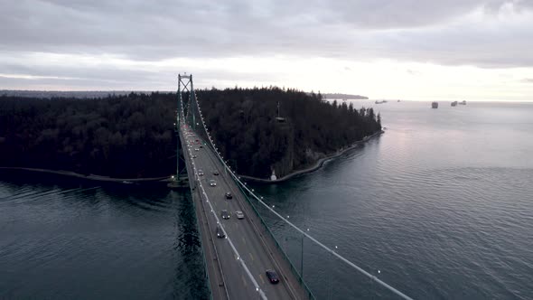 Cars driving along famous Lions Gate Bridge, Vancouver in Canada. Aerial drone view