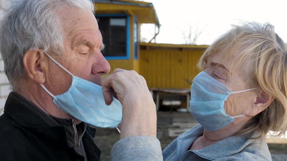 Elderly Woman Put On Her Husband Medical Mask To Protect Virus And Illness