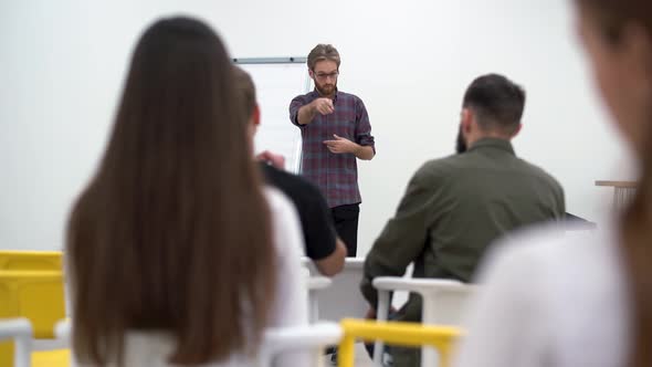 Businessman Presenting New Project To Diverse Partners with Flip Chart