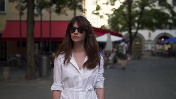 Gimbal Shot of Woman Walking in White Long Dress in Munich