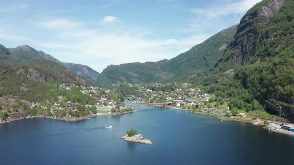 A boat passing Sorfjorden at Stanghelle - Idyllic village in Vaksdal - Sideways moving ascending aer