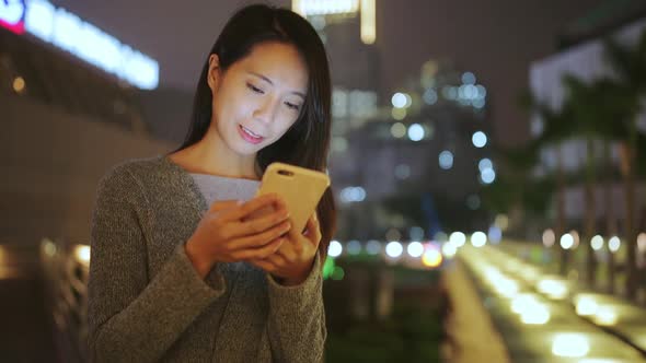 Woman use of smart phone at night 