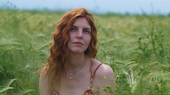 Portrait of Attractive Female on Grass at Sunset