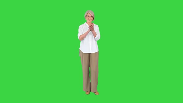 Smiling Applauding Old Woman in Glasses on a Green Screen Chroma Key