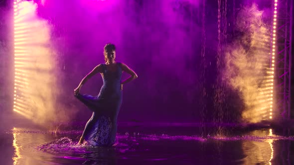 A Charming Middle Aged Woman Passionately Dances Flamenco Among Raindrops and Splashing Water,  Smoky