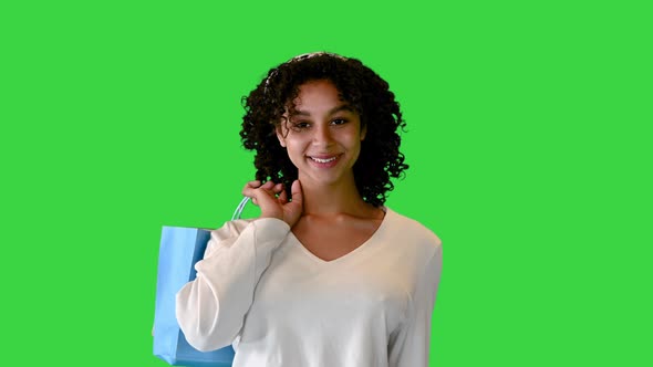 Cheerful Black Woman with Curly Hair Shopping on a Green Screen Chroma Key