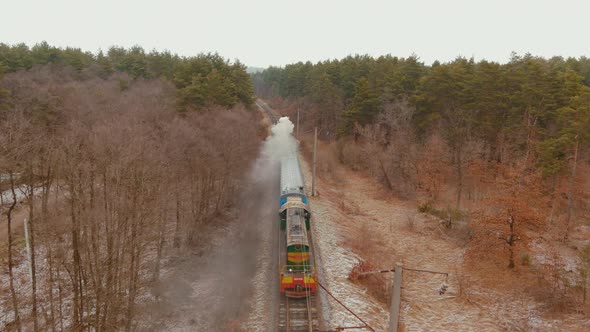 Aerial of an Antique Restored Steam Locomotive Blowing Smoke Steam Traveling