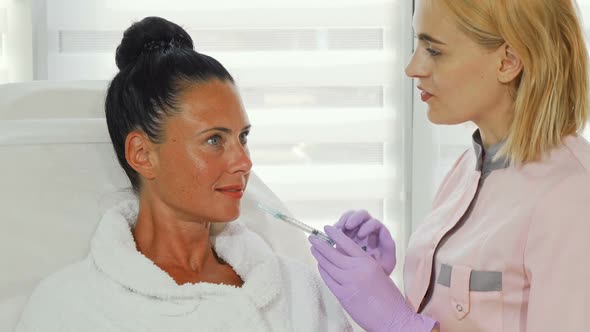 Professional Cosmetologist Talking To Her Female Client