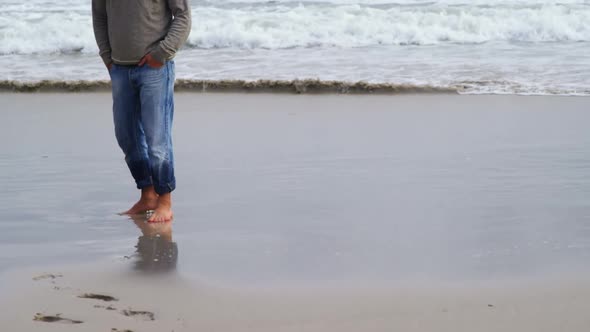 Mature man standing on the beach