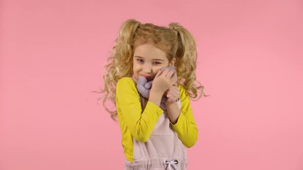 Cute Blond Girl Is Hugging Her Teddy-bear