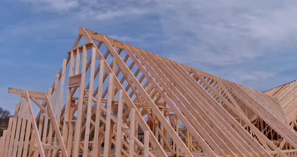 Panoramic View of Wooden Frame House Under Construction Roof Beams