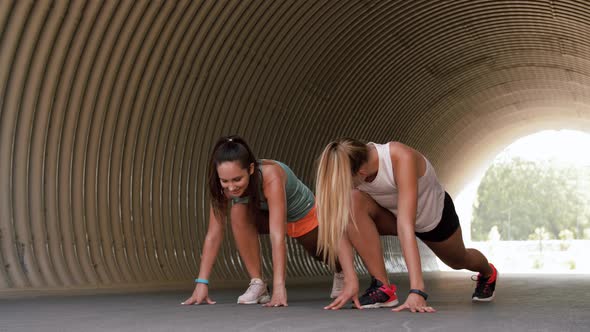 Women with Fitness Trackers Stretching Outdoors