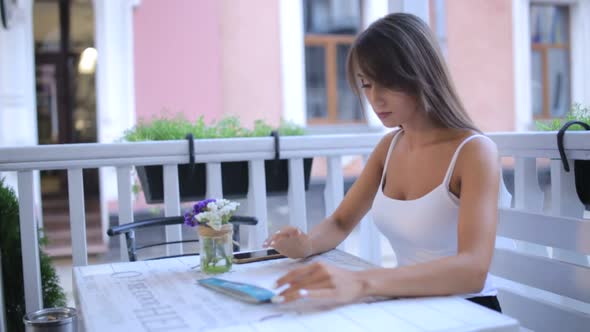 Beautiful Woman Looking at Menu in Restaurant