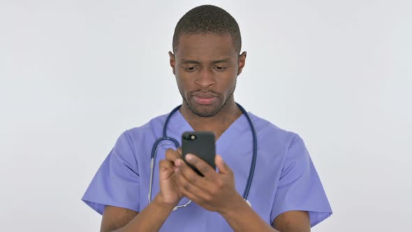 African Doctor Browsing Smartphone on White Background