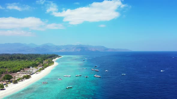 Wide birds eye copy space shot of a white sand paradise beach and blue water background in colourful