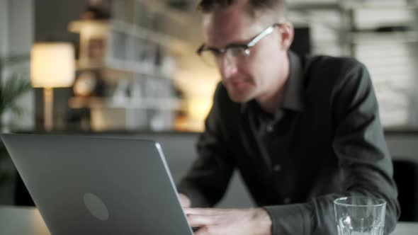 Young Man Freelancer Using Laptop Online Working From Office In Internet, Smiling Focused Millennial