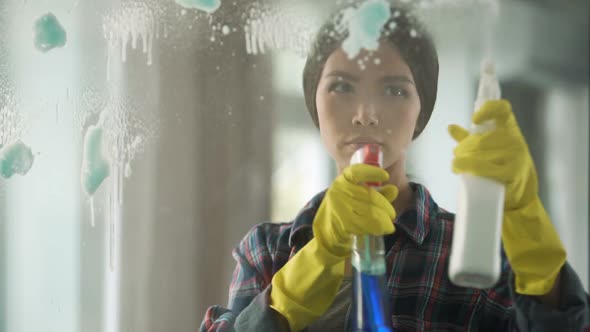 Housewife Spraying Different Window Cleaners on Glass, Bringing House to Order