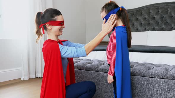 Mother and daughter pretending to be superhero 