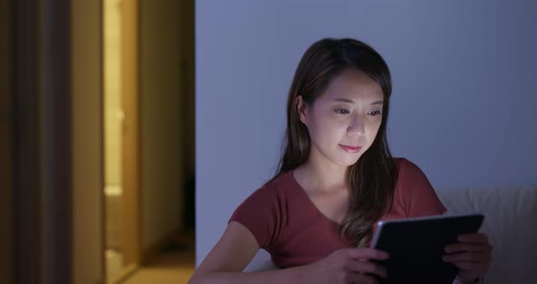 Woman watch on the tablet at home at  night 