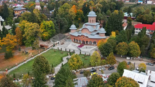 Aerial drone view of The Monastery of Curtea de Arges, Romania. Square with greenery