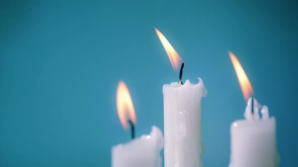 Burning Candles On A Blue Background
