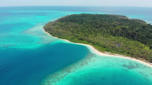 Aerial: flying over exotic tropical island secluded destination away from it all