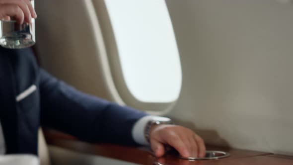 Businessman Drinking Fresh Water on Airplane Trip