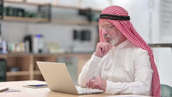 Senior Old Arab Businessman Thinking and Working on Laptop