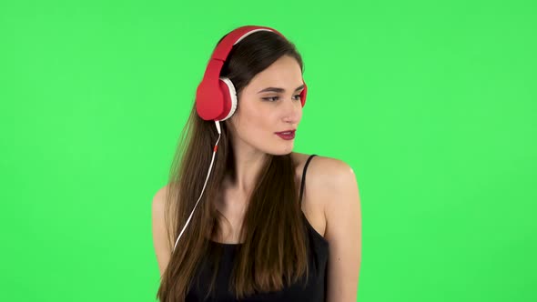 Cheerful Girl Dancing and Enjoys Music in Big Red Headphones