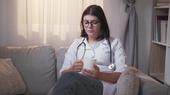 Doctor Drinking Coffee Work Break Woman Couch