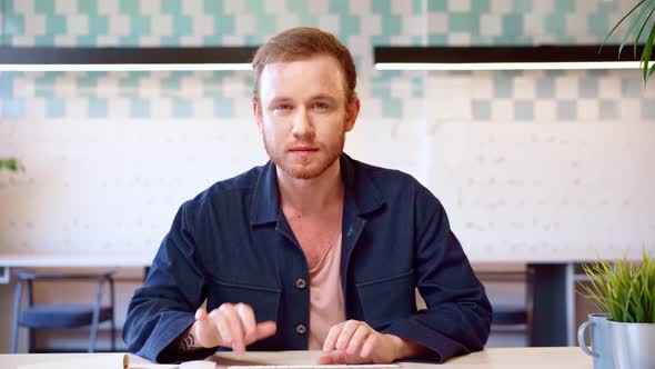 Young Casual Man Typing on Computer Keyboard Satisfied with the Result